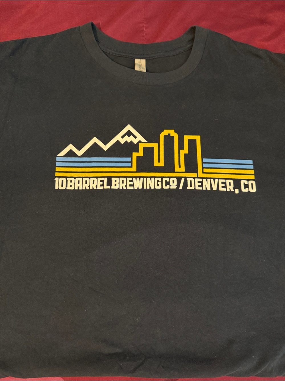 Next Level Apparel Black Tee with Yellow and Blue Denver Skyline Graphic